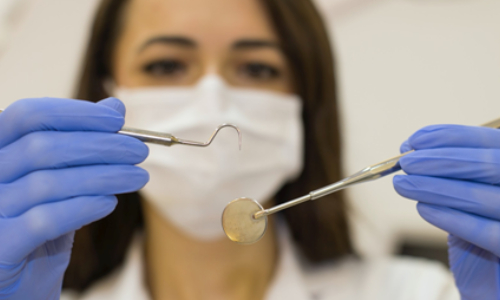 Dentist holding Dental Equipment